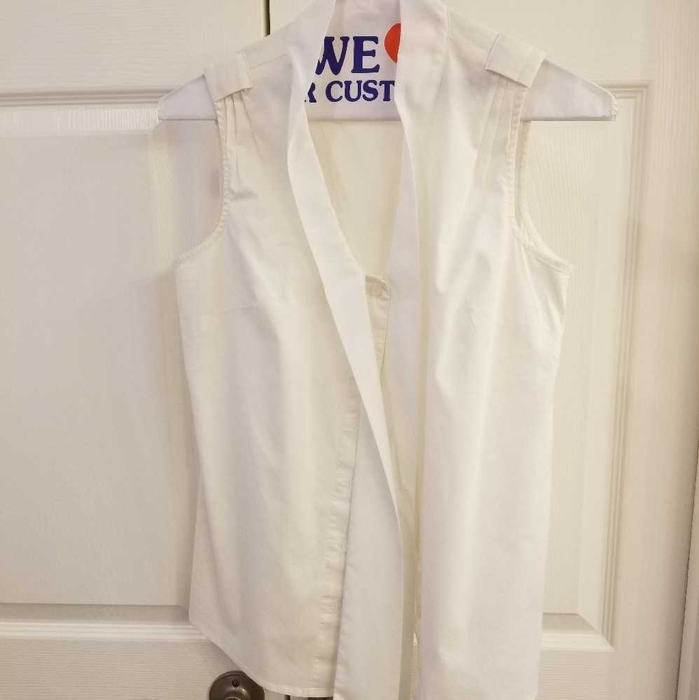 White sleeveless button up top with neck tie